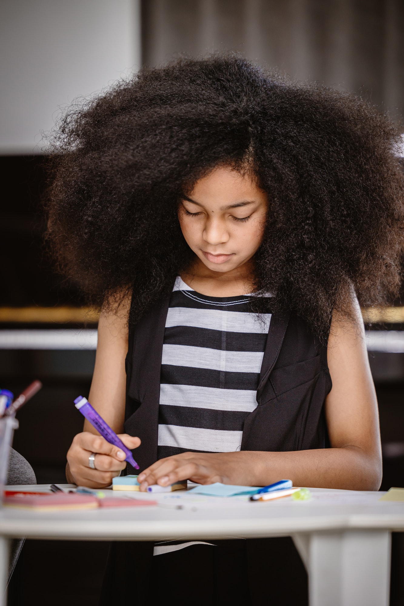African teenager with afro hair engaged in learning at PalTutors education center.