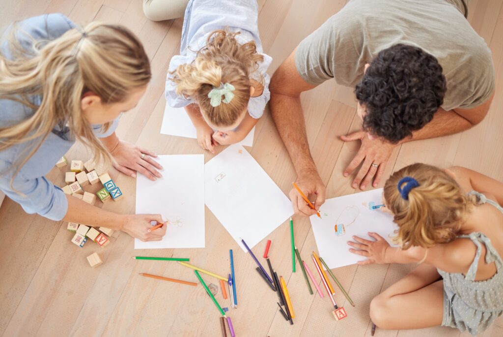 Family with creative children drawing on paper, home school and fun educational activity, learning